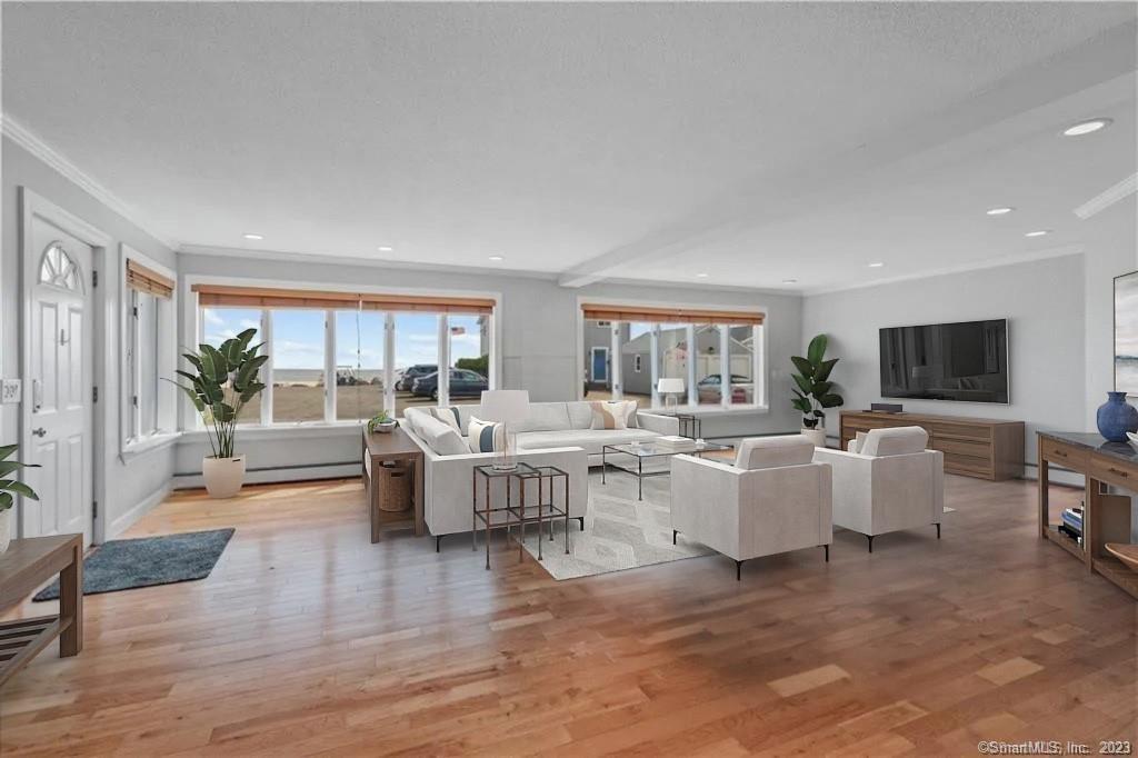 a living room with couches a coffee table and a flat screen tv