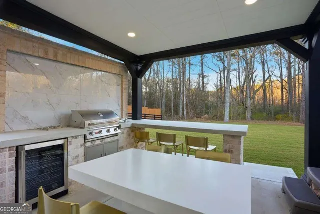 a large white kitchen with a large window