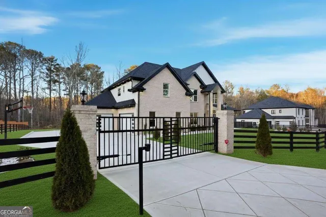 a front view of a house with a garden and plants