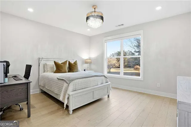 a bedroom with a bed lamp and window