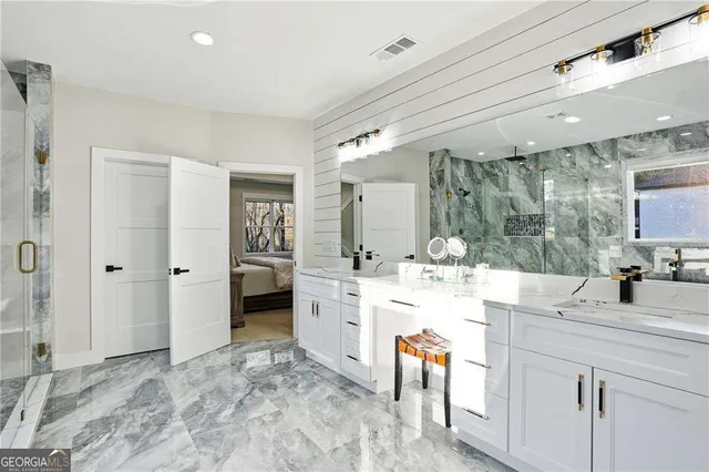 a bathroom with a double vanity sink mirror and shower