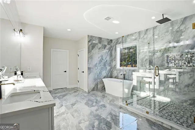 a spacious bathroom with a granite countertop sink a mirror and shower