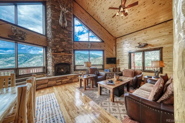 a living room with furniture fireplace and a large window