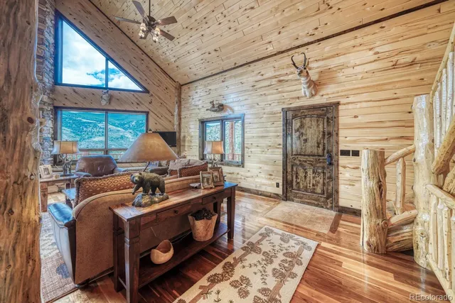 a living room with couches and dryer on the wall