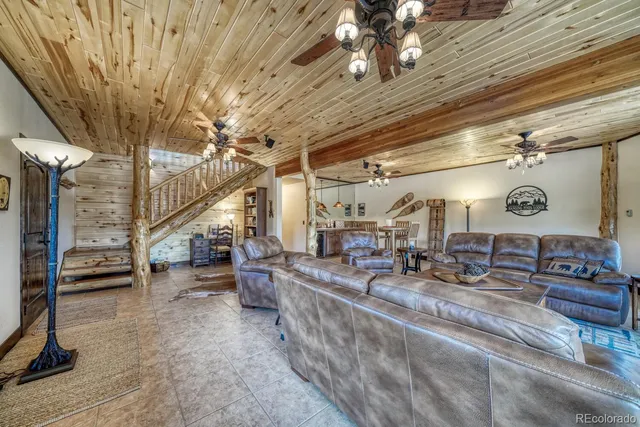 a living room with lots of furniture and a fireplace