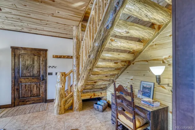 a view of a porch with furniture and a yard