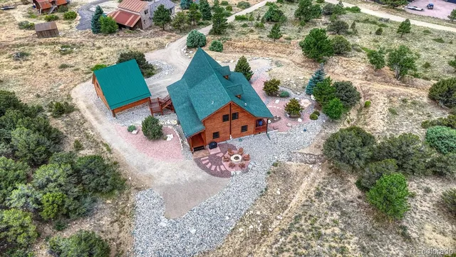 an aerial view of a house with a yard