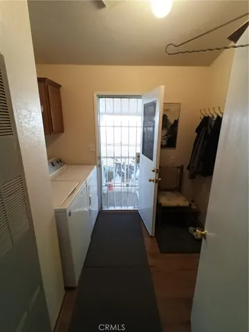 a view of hallway with furniture and a window