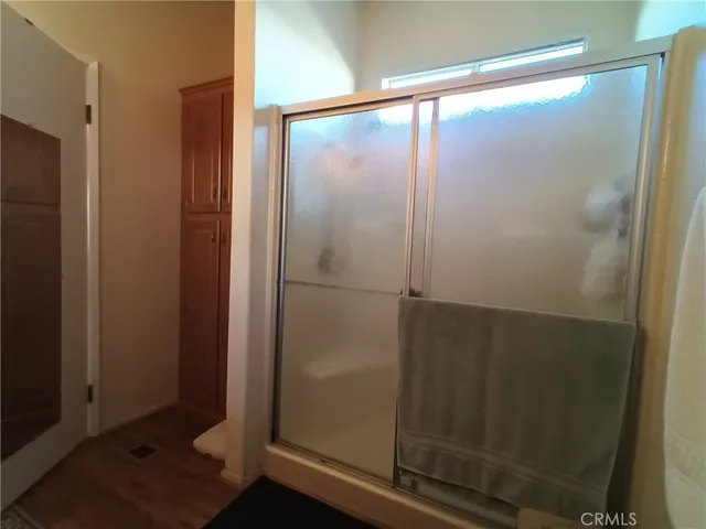 a bathroom with a glass shower door