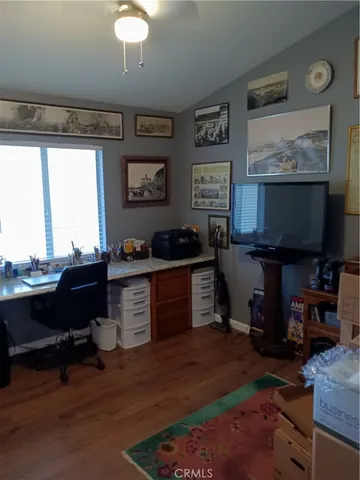 a kitchen with a refrigerator and a stove top open
