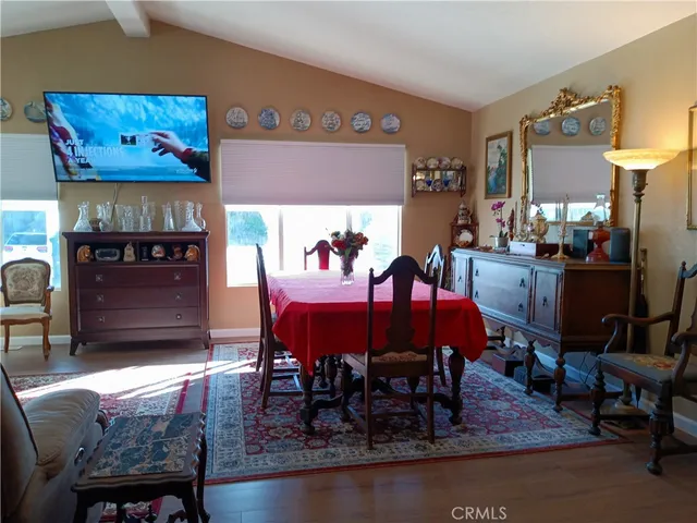 a view of a dining room with furniture and chandelier