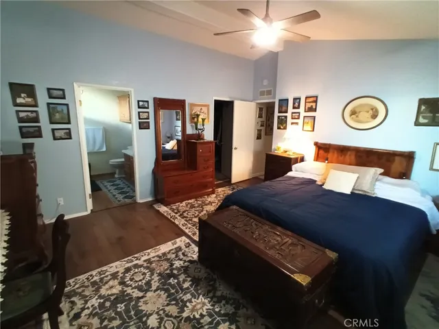 a bedroom with bed and wooden floor