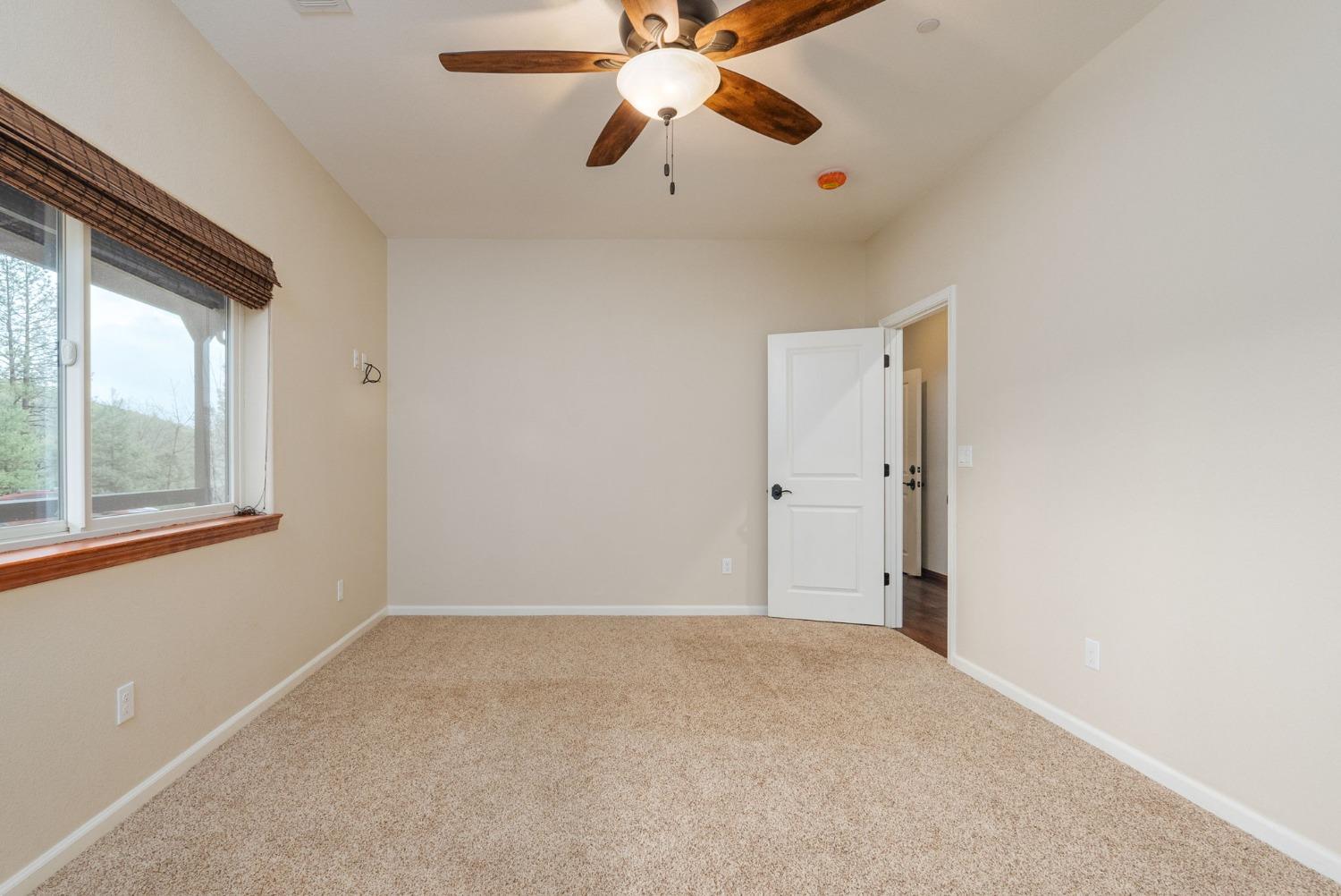 9080 El Dorado Trail Mountain Ranch, CA 95246 - Photo 33 of 48 a view of an empty room with window and a chandelier fan