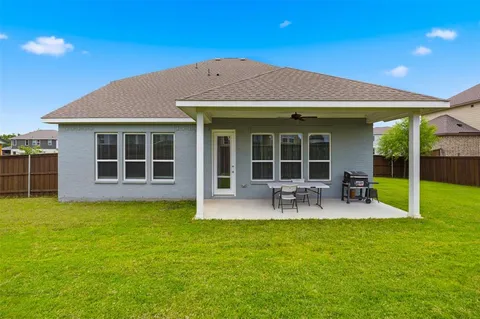 a view of a house with a backyard porch and sitting area