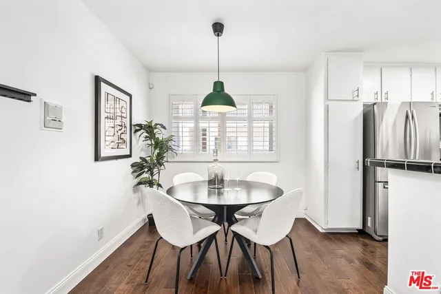 a dining room with furniture a chandelier and wooden floor