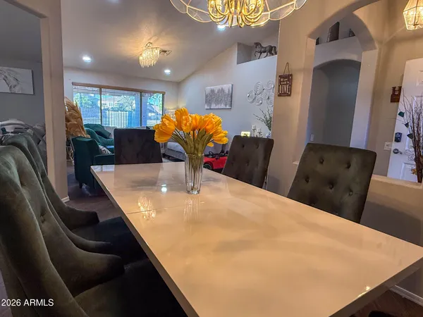 a dining room with furniture and chandelier