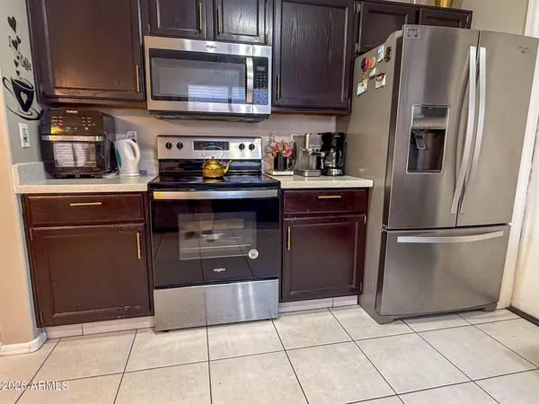 a kitchen with stainless steel appliances granite countertop a refrigerator and a stove