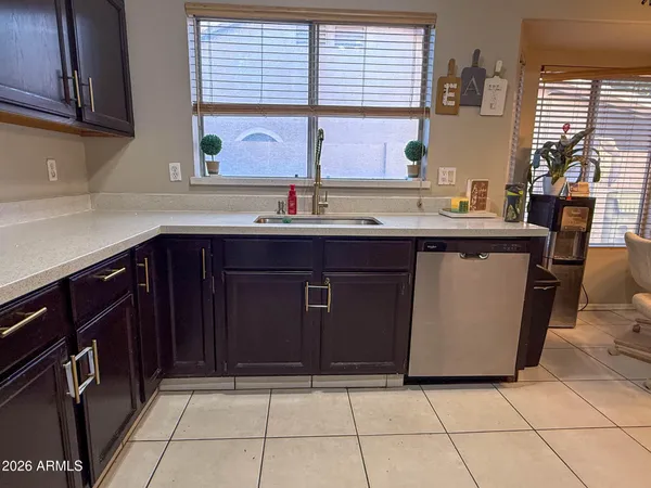 a kitchen with a sink window and cabinets