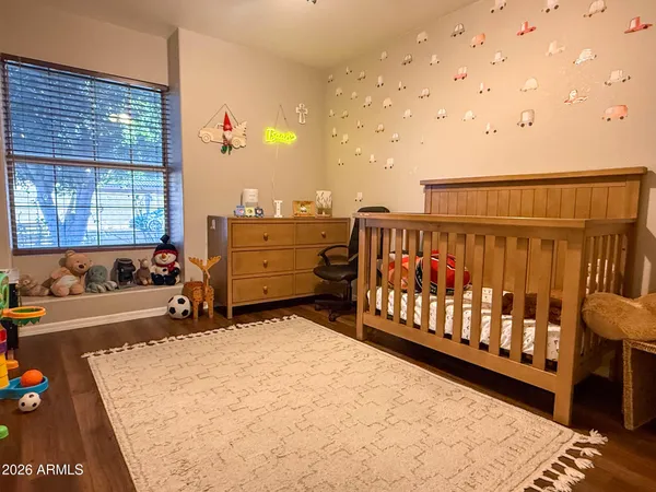 a spacious bedroom with a bed and a window
