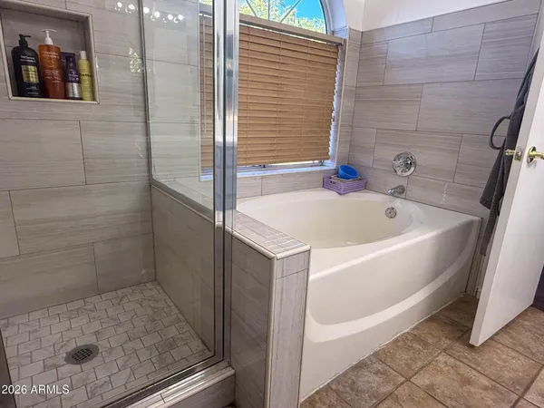 a bathroom with a tub and shower