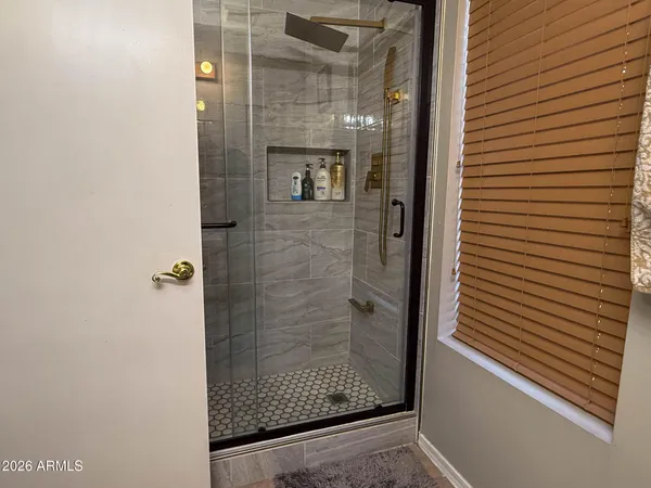 a bathroom with a glass shower door