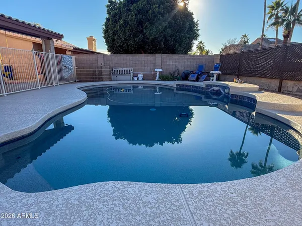 a swimming pool view with a outdoor seating