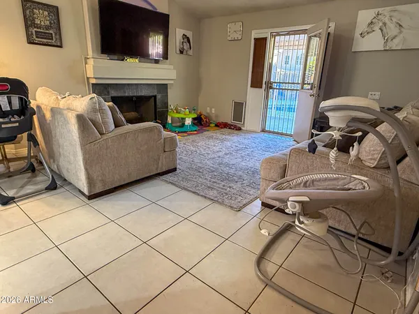 a living room with furniture and a fireplace