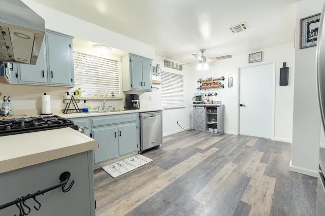 a kitchen with a sink stove and refrigerator