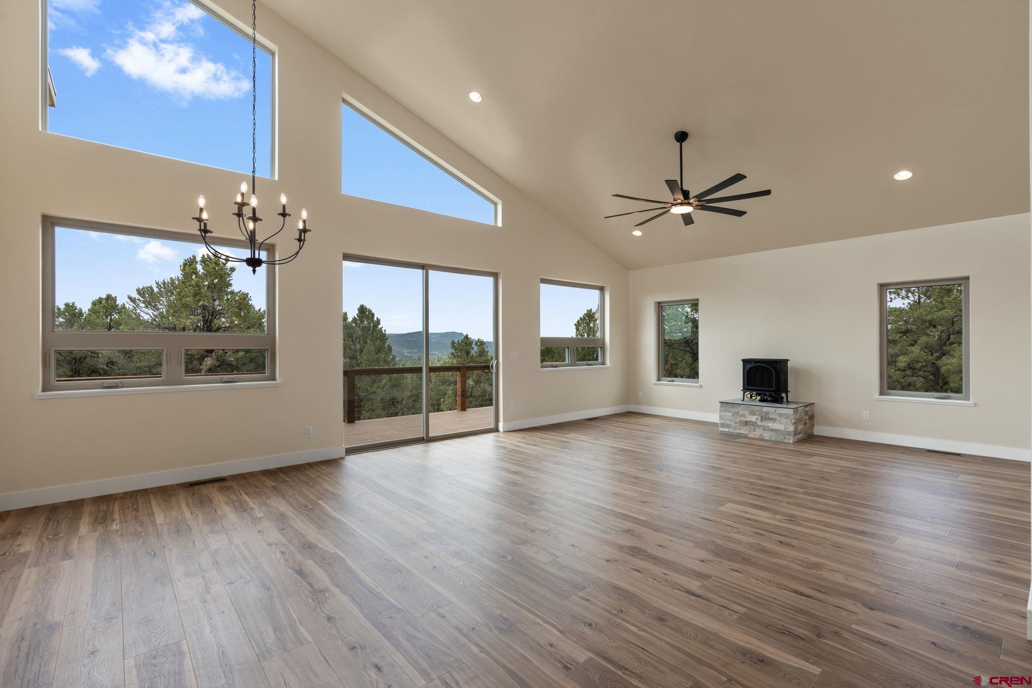 640 Sawmill Road Durango, CO 81303 - Photo 8 of 42 a view of an empty room with wooden floor and a window