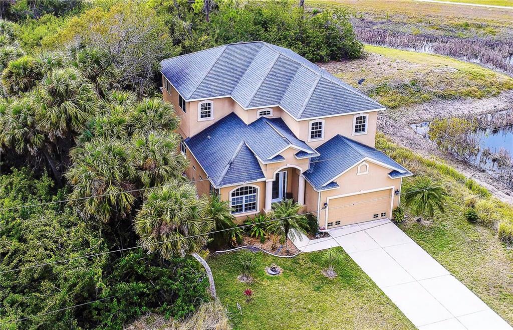 358 Sunset Road Rotonda West, FL 33947 - Photo 1 of 1 Aerial shot of this lovely home. Private, vacant lot to the rear and to the left side. Pond on the right.