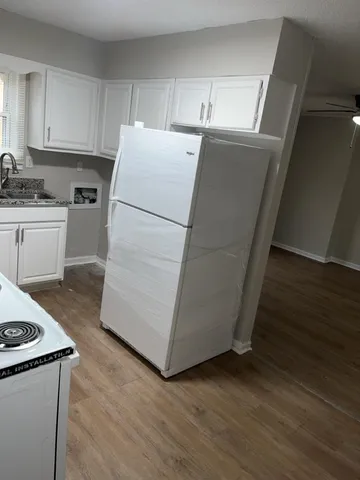 a white refrigerator freezer sitting inside of a kitchen