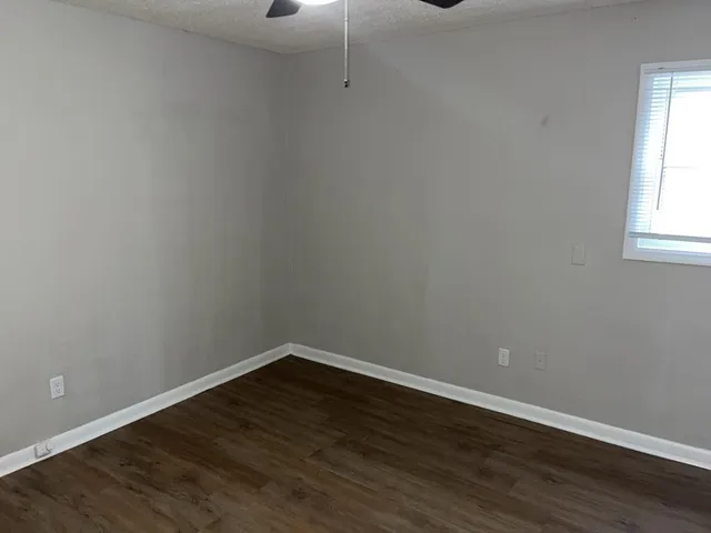 a view of a small space with wooden floor and windows
