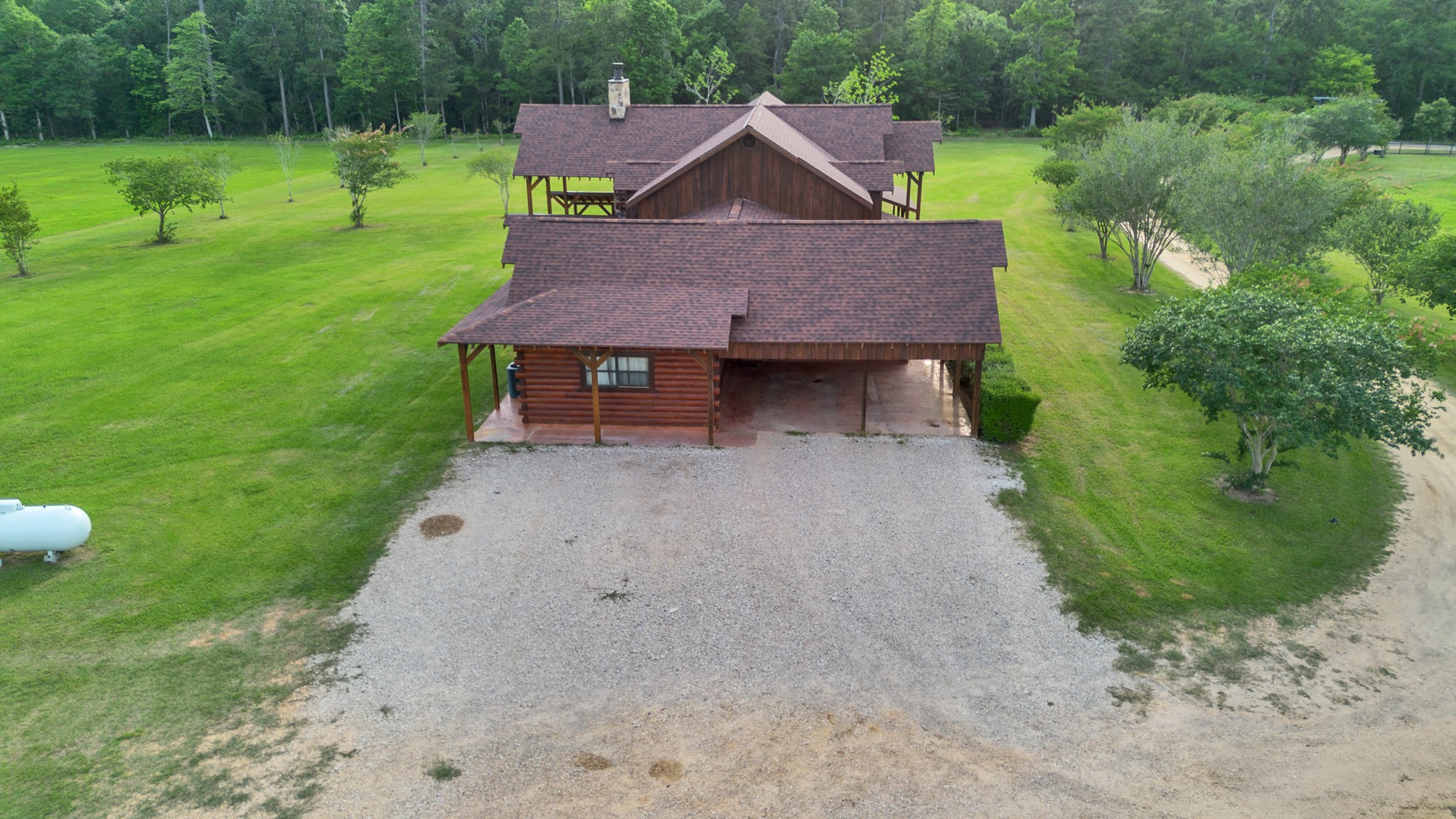 325 Forest Service 217 Road Shepherd, TX 77371 - Photo 19 of 46 a aerial view of a house with table and chairs in a yard