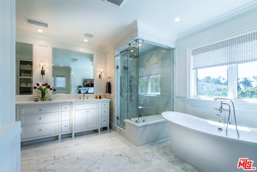222 20th Street Santa Monica, CA 90402 - Photo 21 of 44 a bathroom with a granite countertop sink mirror bathtub and toilet