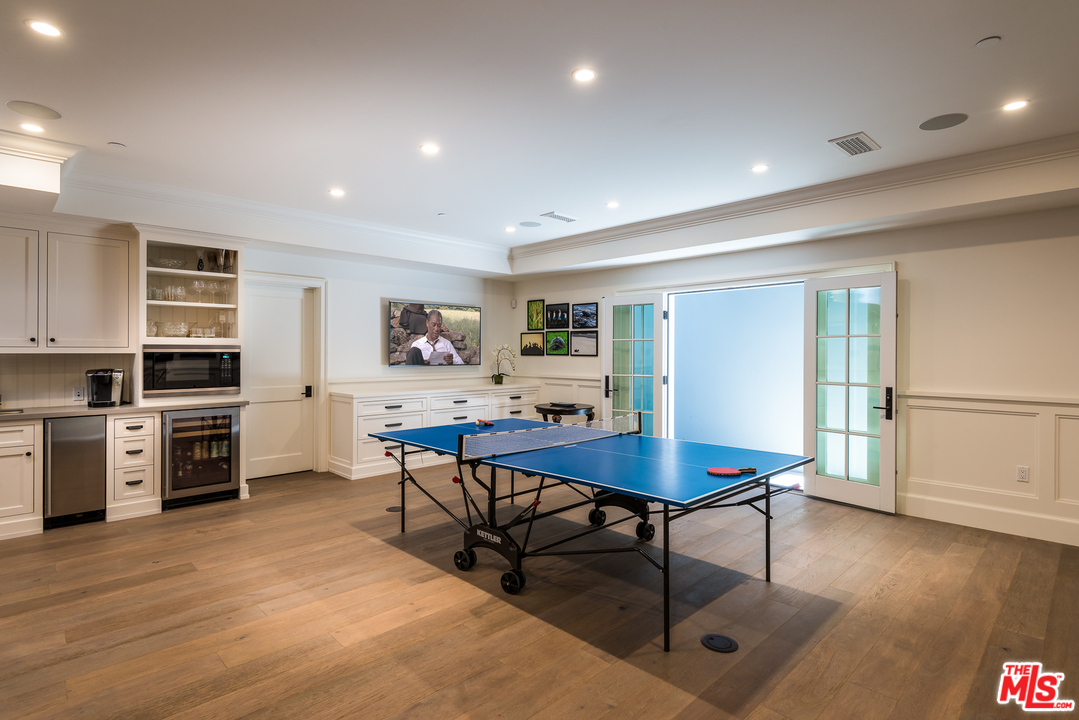 222 20th Street Santa Monica, CA 90402 - Photo 28 of 44 a living room with stainless steel appliances kitchen island granite countertop a table chairs and a refrigerator