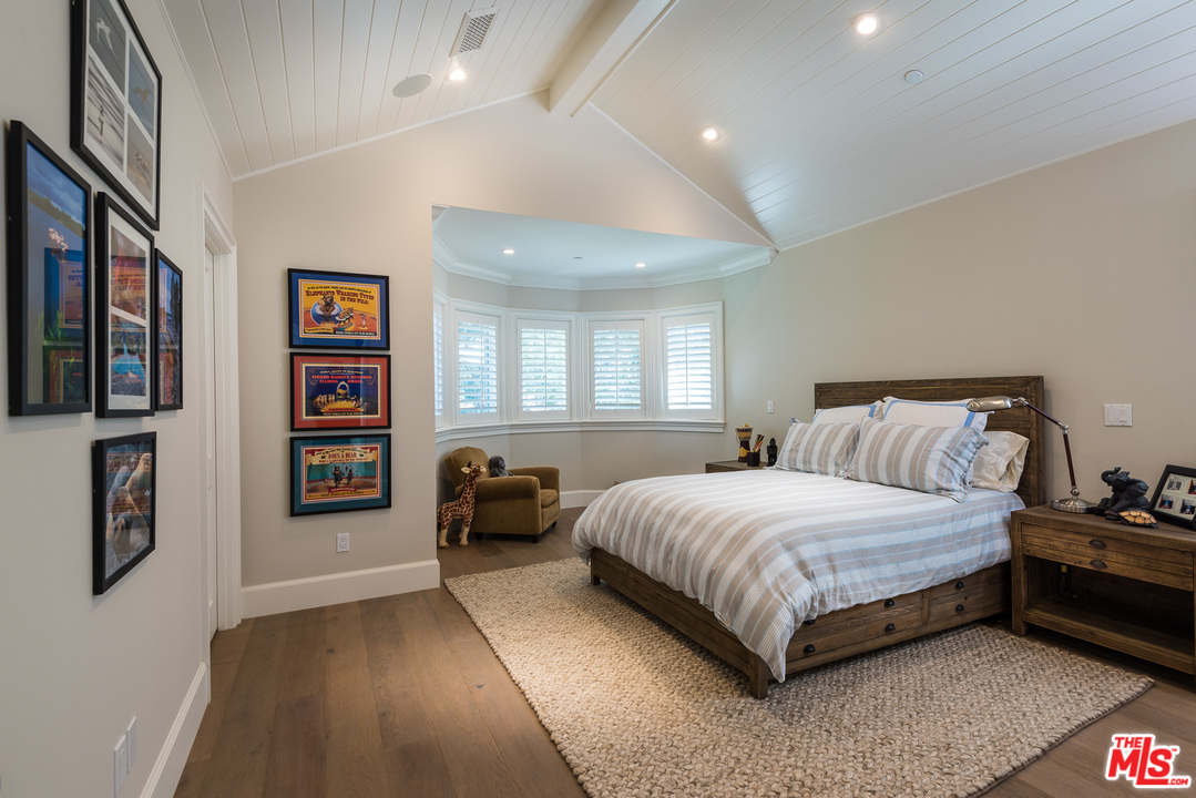 222 20th Street Santa Monica, CA 90402 - Photo 31 of 44 a bedroom with a bed couch and a window