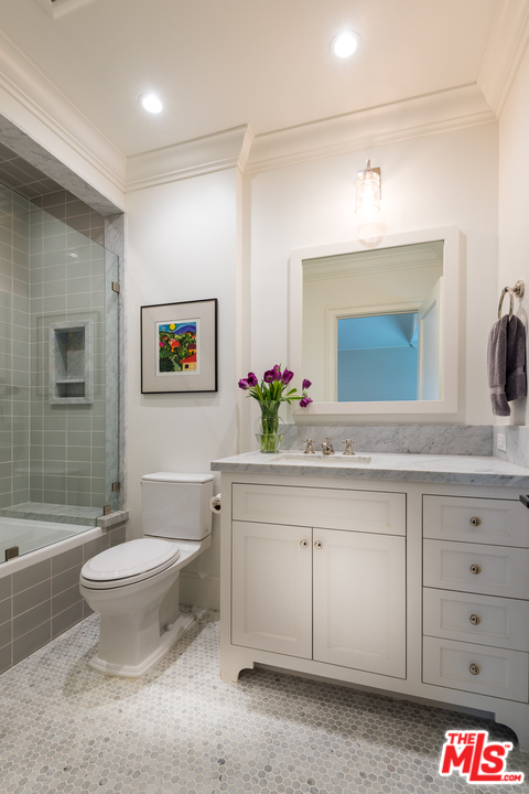 222 20th Street Santa Monica, CA 90402 - Photo 32 of 44 a bathroom with a toilet sink and mirror