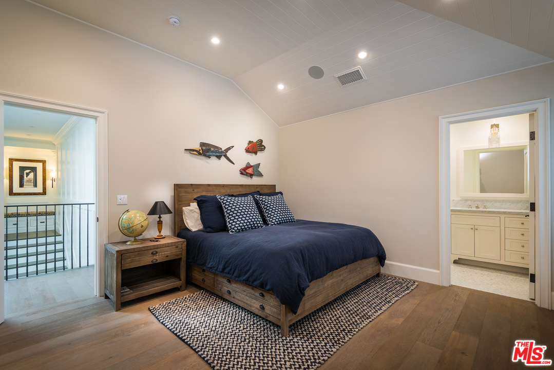 222 20th Street Santa Monica, CA 90402 - Photo 35 of 44 a bedroom with a bed and wooden floor