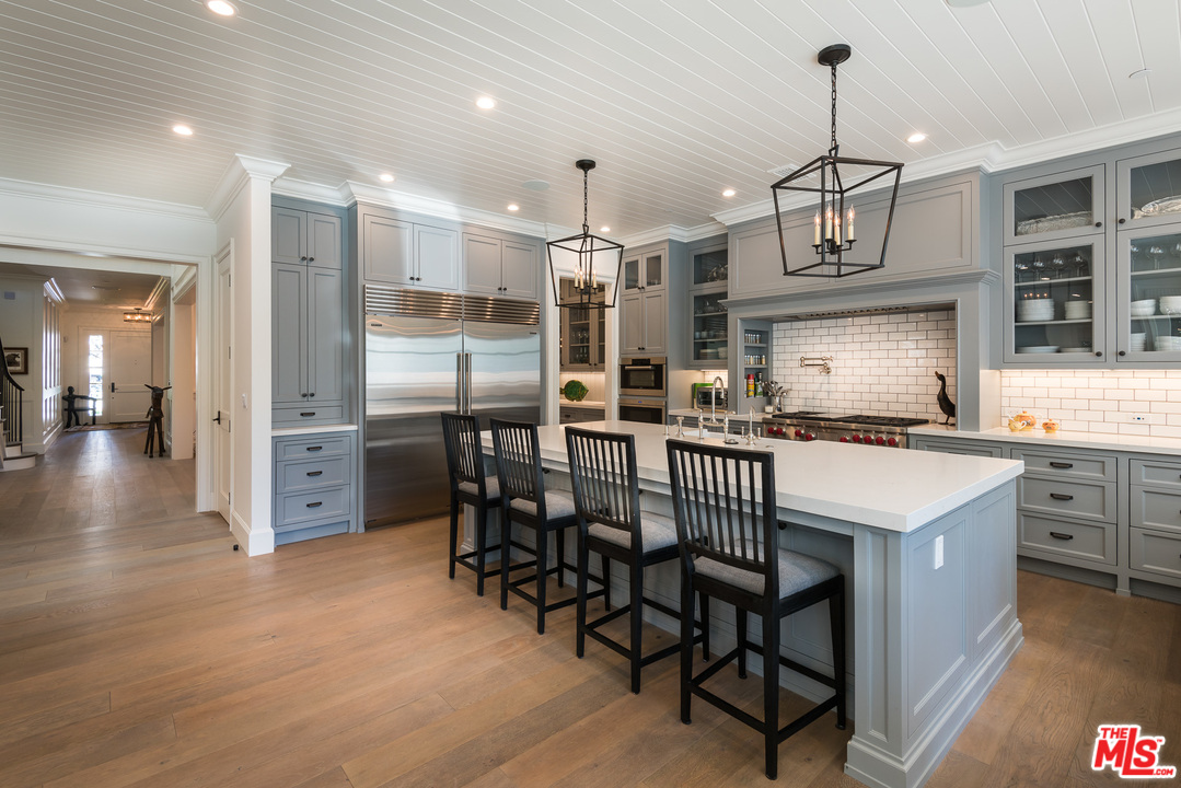 222 20th Street Santa Monica, CA 90402 - Photo 8 of 44 a kitchen that has a lot of cabinets in it and stainless steel appliances