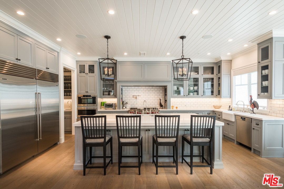 222 20th Street Santa Monica, CA 90402 - Photo 9 of 44 a kitchen with stainless steel appliances granite countertop a kitchen island a table and chairs