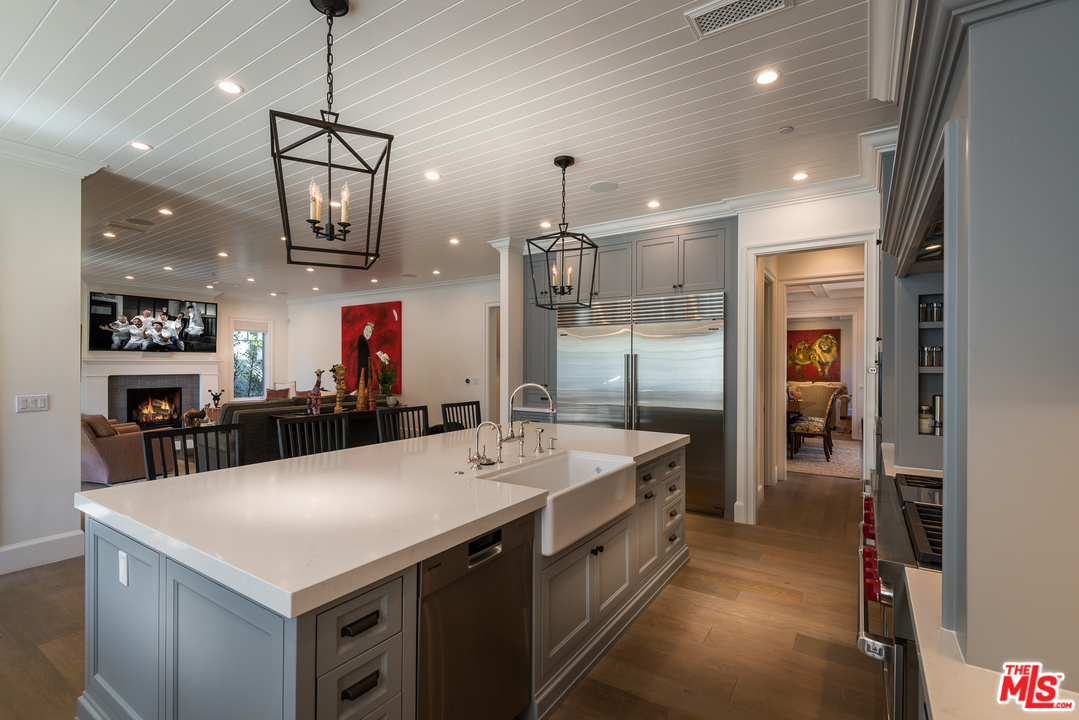 222 20th Street Santa Monica, CA 90402 - Photo 10 of 44 a large kitchen with kitchen island a sink appliances and a chandelier