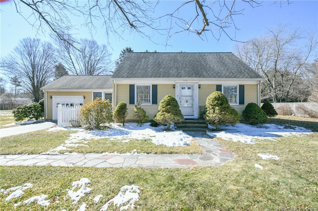 a front view of house with yard and trees around