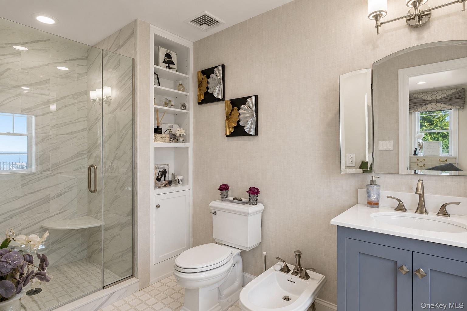 65 Shore Road Westhampton, NY 11977 - Photo 17 of 24 Spacious bathroom featuring a glass-enclosed shower with a built-in bench, light-toned wall tiling, and a window