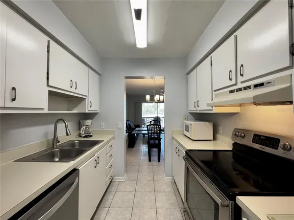 a stove top oven sitting inside of a kitchen