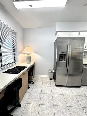 a kitchen with a refrigerator and a sink