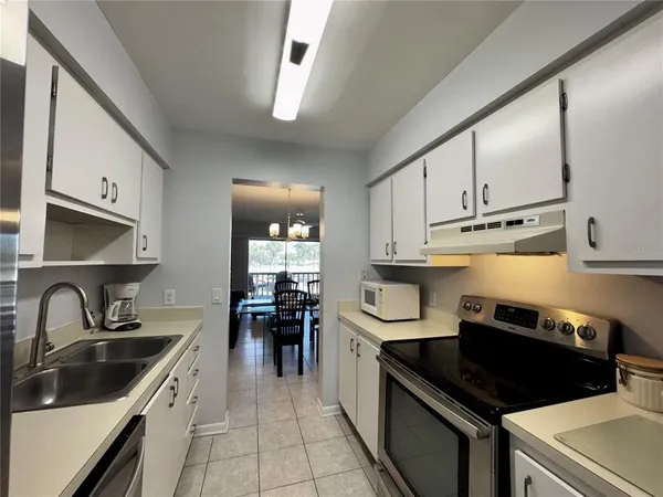 a bedroom with two beds and a lamp