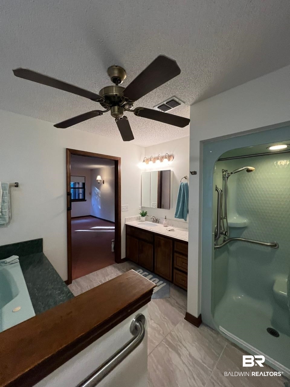2682 Pine Ridge Drive Lillian, AL 36549 - Photo 12 of 37 Bathroom featuring vanity, ceiling fan, a shower, and a textured ceiling