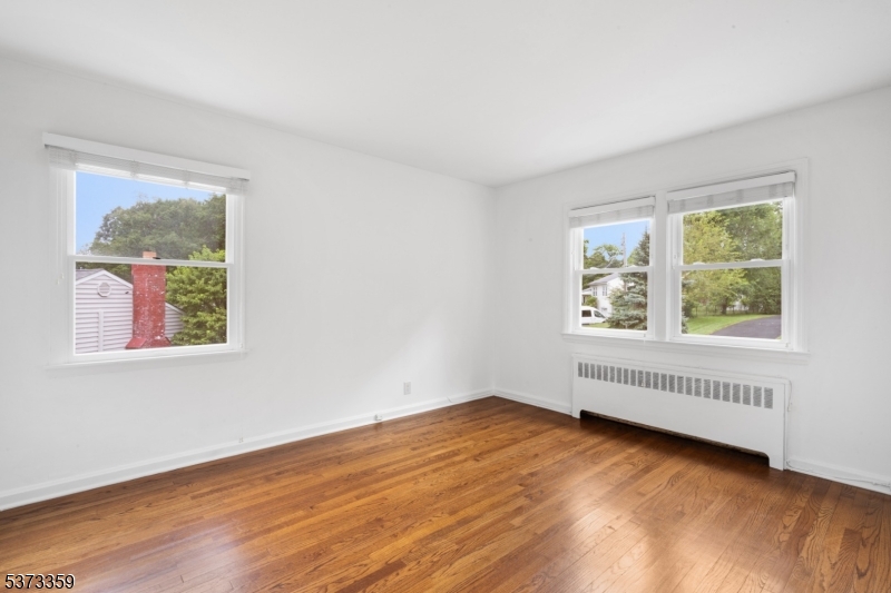 1 Baldwin Road Florham Park, NJ 07932 - Photo 19 of 33 a view of an empty room with wooden floor and a window