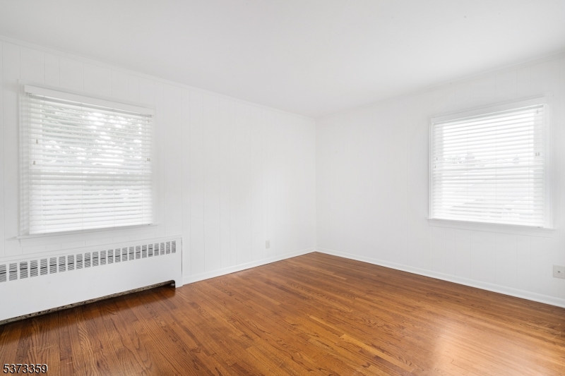 1 Baldwin Road Florham Park, NJ 07932 - Photo 21 of 33 a view of an empty room with wooden floor and a window