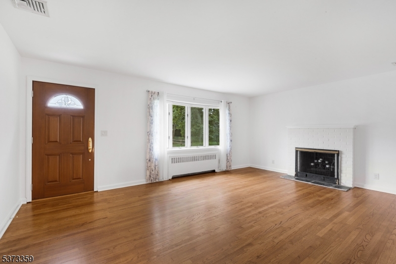 1 Baldwin Road Florham Park, NJ 07932 - Photo 6 of 33 an empty room with windows and a fireplace